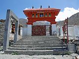 402 Muktinath Entrance The entrance gate welcomed me to the temples of Muktinath (3750m), a holy place for both Hindus and Buddhists, located in a walled complex among a sacred grove of poplar trees. After Pashupatinath, Muktinath is Nepal's most sacred Hindu site. The Hindus call the place Mukti Kshetra, which literally means the place of salvation, while the Buddhists call it Chumig Gyatsa, which in Tibetan means Hundred Waters.
